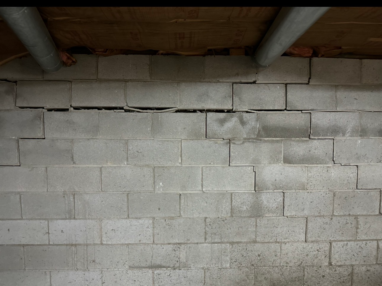 Cracked concrete block wall in basement